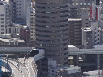 This Highway in Japan Passes Through Three Floors of an Office Building The Hanshin Expressway goes right through the 5th, 6th, and 7th floors of the high-rise.